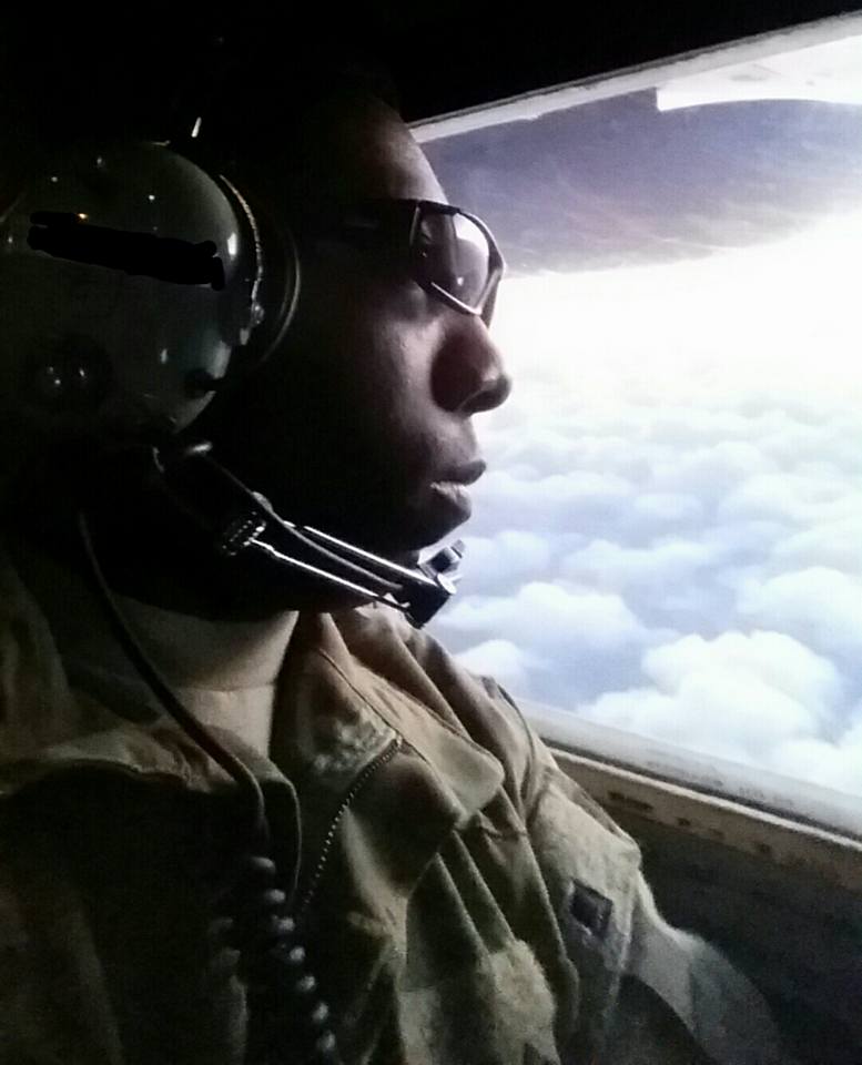 Image of Wilkinson, flying in a military aircraft. Gazing out of the window. It is obvious, that he is deep thought.